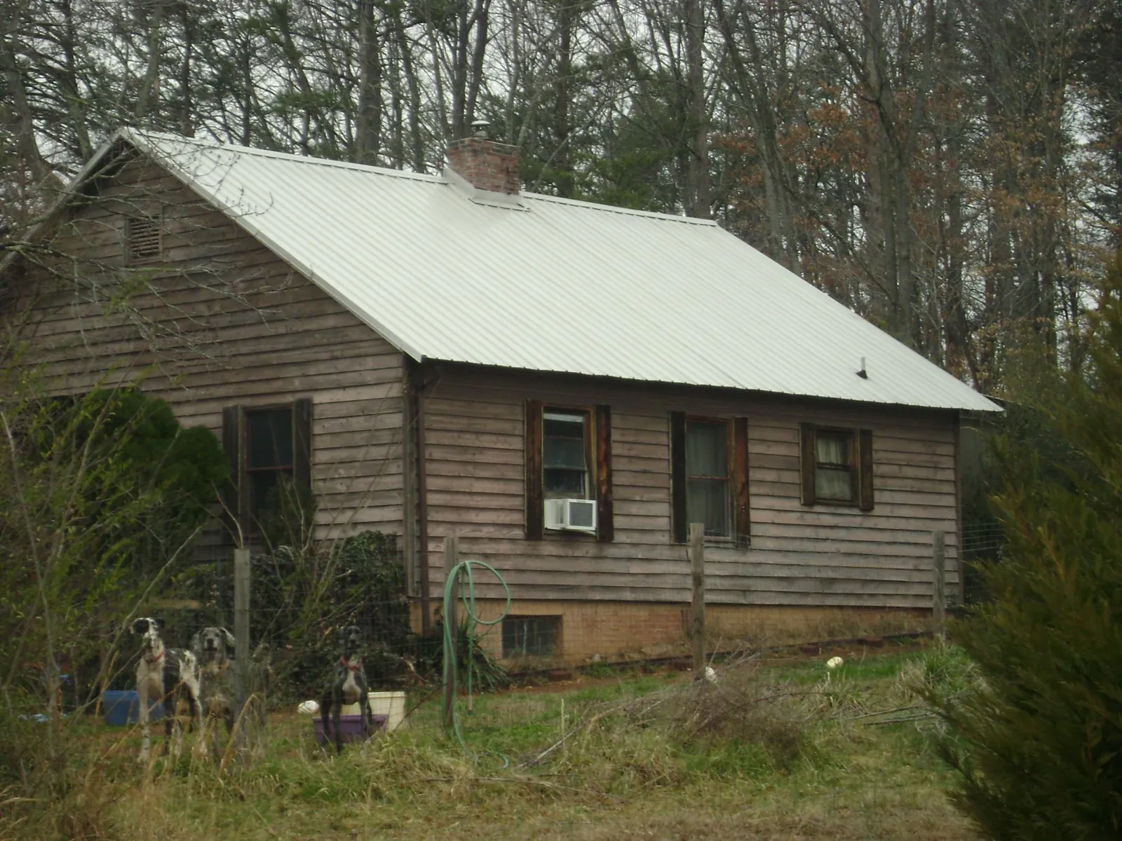 White metal roof on an old wood sided farmhouse, from a Metal Roof Installation job in Irvine